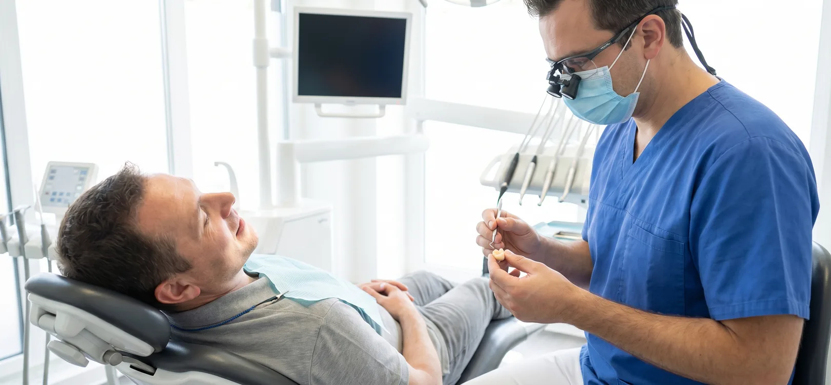 Dentist evaluating a crown restoration for a patient